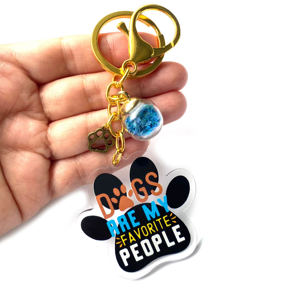 Acrylic paw-shaped keychain with motivational dog lover quote and gold clasp