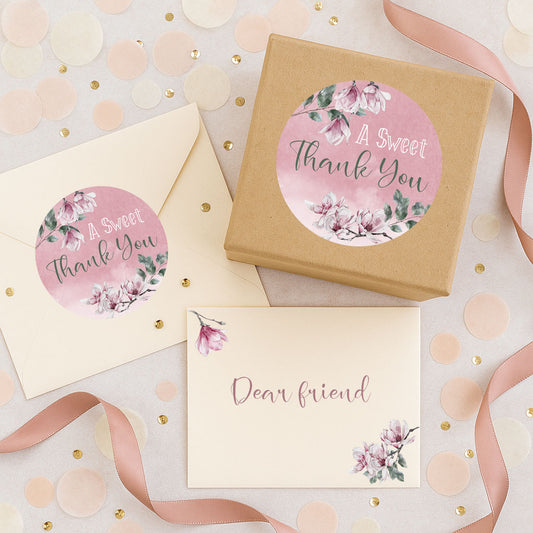 Gift box, card, and envelope with floral 'A Sweet Thank You' stickers on a decorative background.