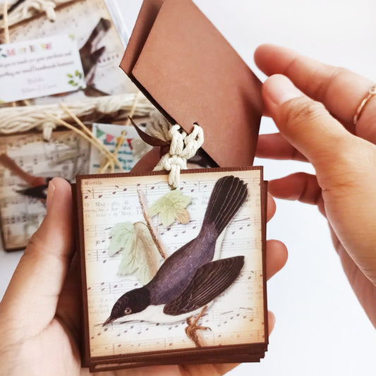 Vintage bird music favor tag layered 2.5 inch square gift tag with cotton string shown in hands for wedding baby shower gift favors