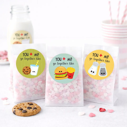 Three treat bags with colorful labels featuring food illustrations and a cookie on a white background.