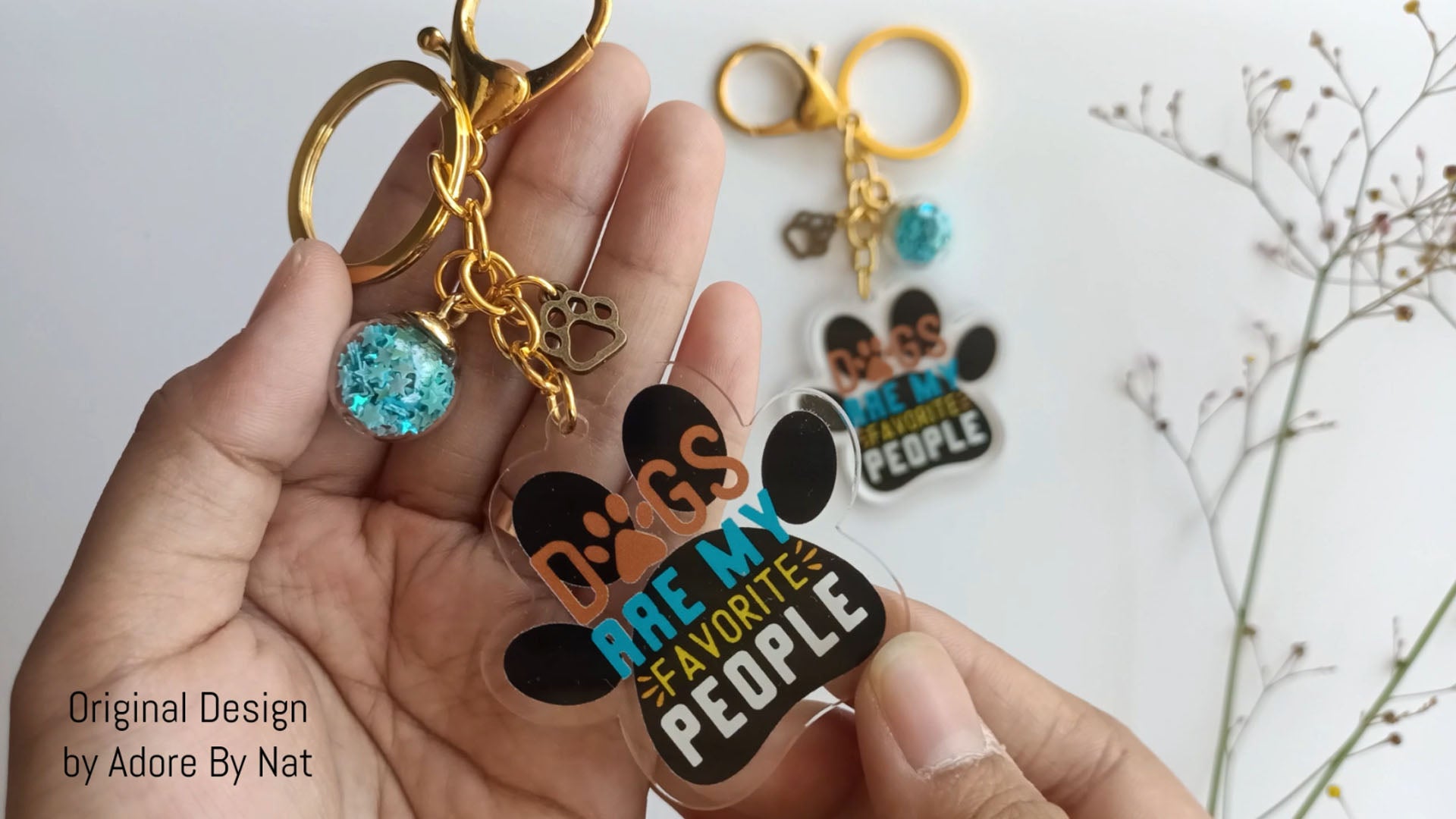 Dog lover gift keychain with acrylic paw charm, blue globe and gold clasp attachment