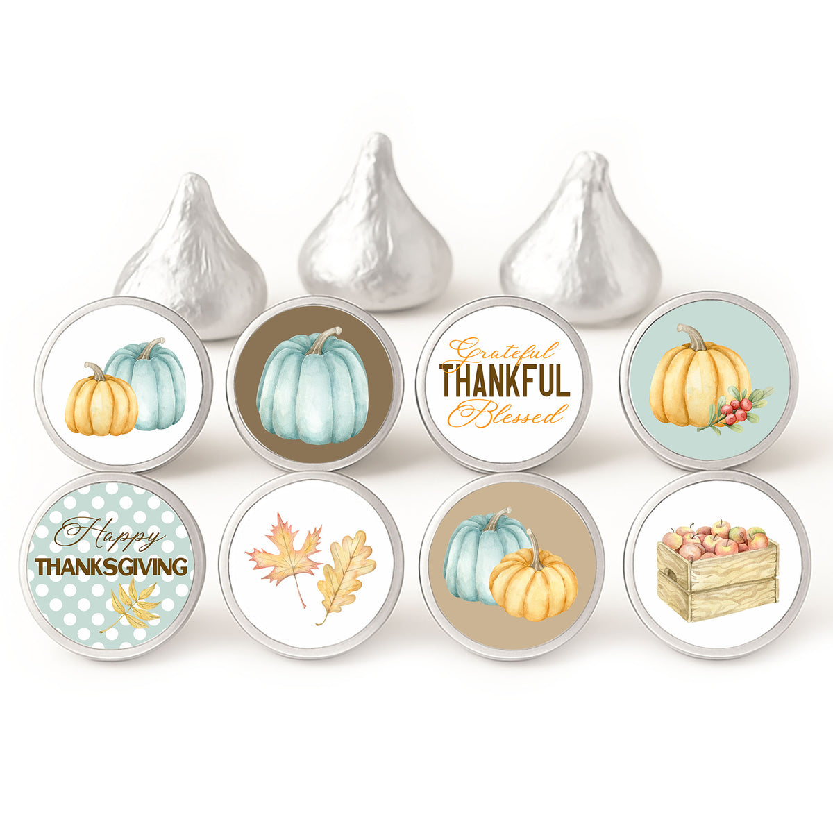 background	Blue pumpkin Thanksgiving candy stickers in eight designs displayed on silver-wrapped chocolates against a white background.