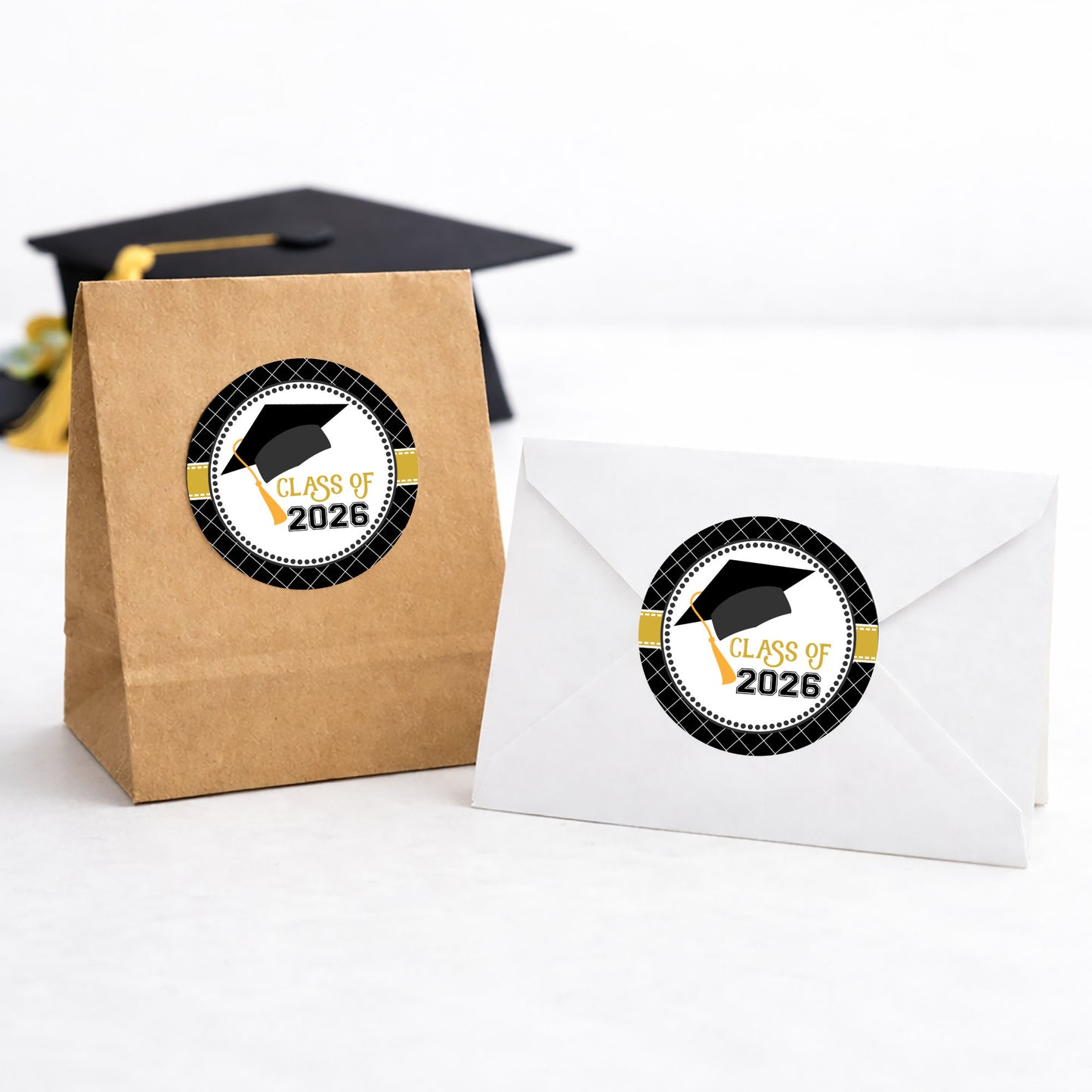 Class of 2026 graduation favor stickers on treat bag and envelope black and gold party theme