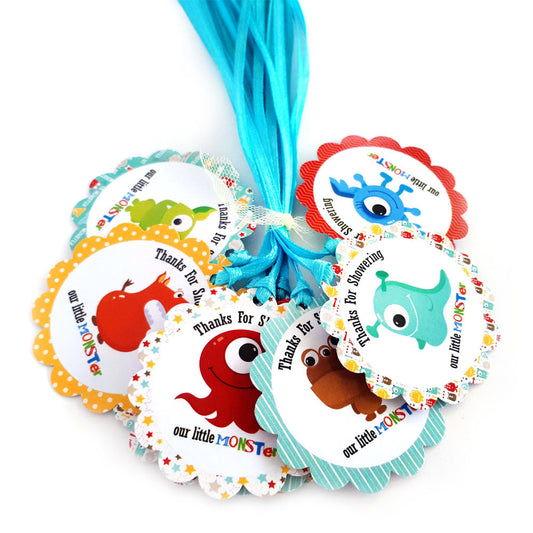 Colorful monster-themed gift tags with ribbons on a white background