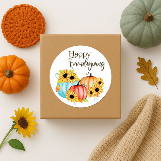Happy Friendsgiving sticker on kraft gift box, styled with pumpkins, sunflowers, and cozy fall decor