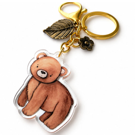 Watercolor brown bear acrylic keychain with gold-tone lobster clasp, split ring, bronze-tone leaf, and small flower charm