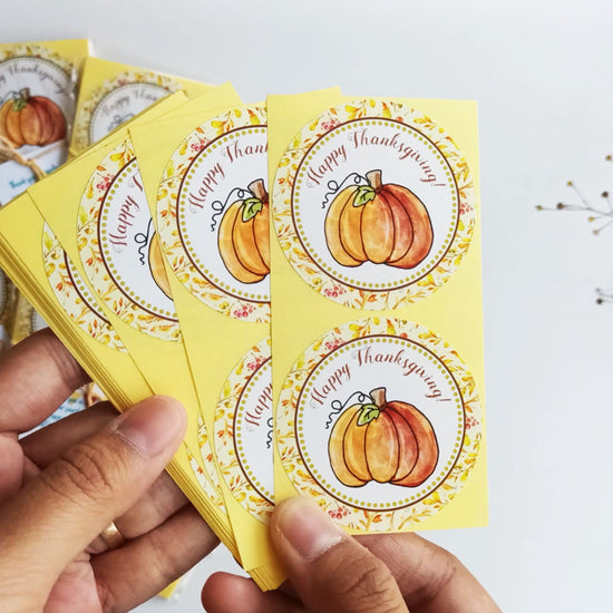 Short demo of Happy Thanksgiving Pumpkin Stickers – 2" round labels with watercolor pumpkin design, perfect for Thanksgiving favors, candy bags, and envelopes.